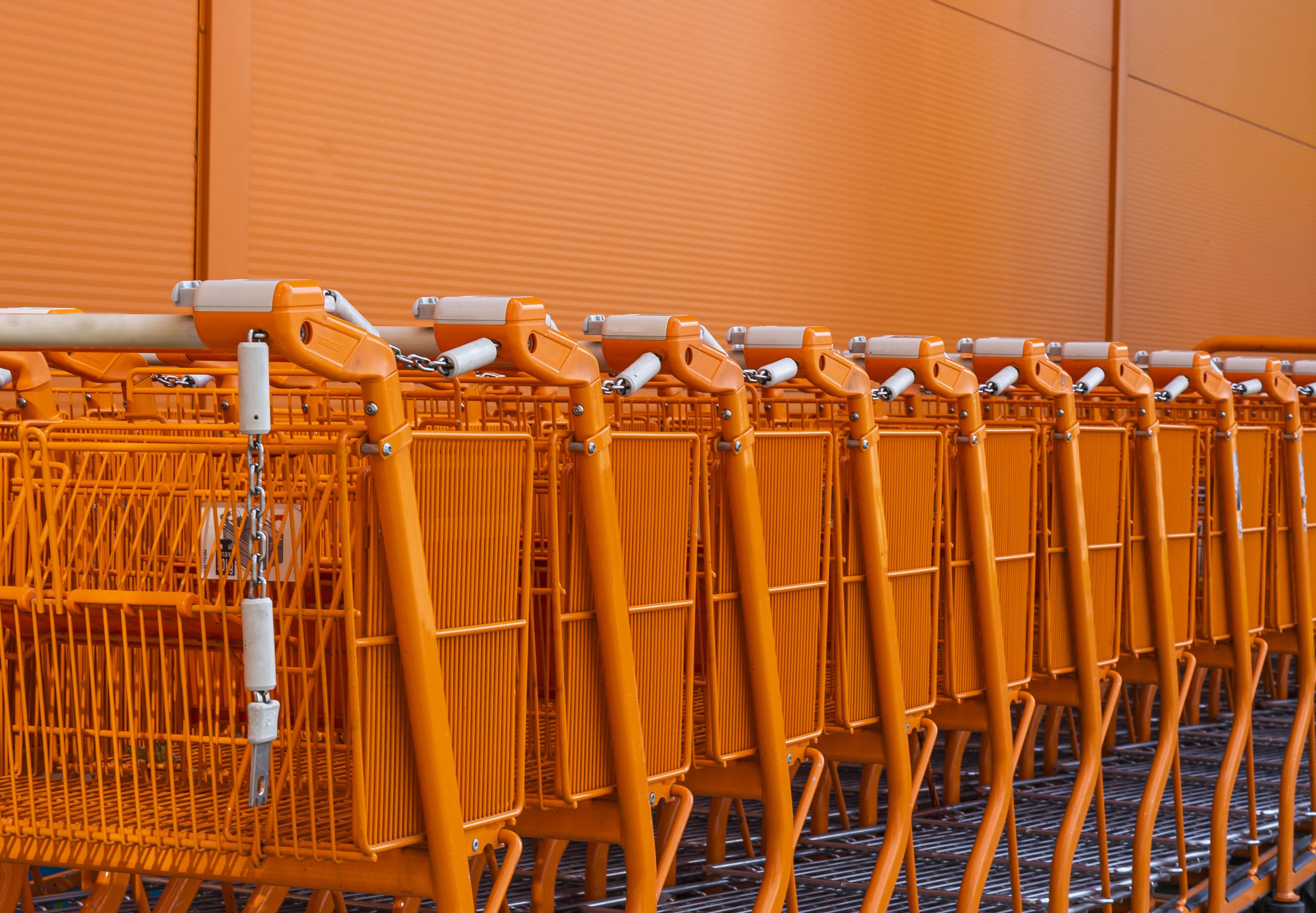 Orange shopping cart stacked by the entrance